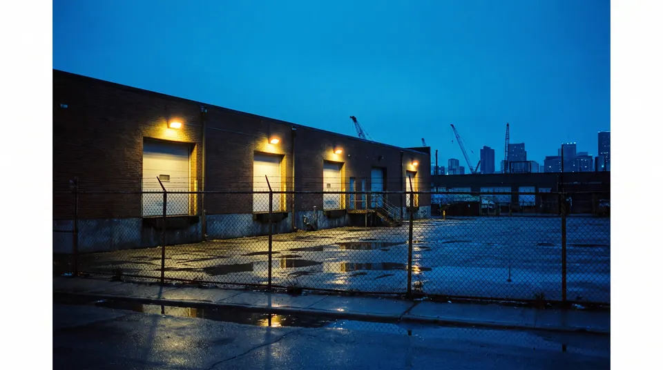 Loading docks at a low brick warehouse at blue hour. Demo photography.
